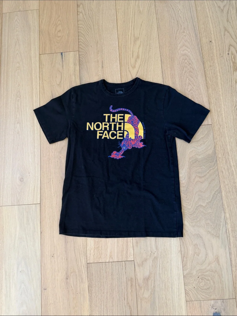 The North Face Black Tee with Yellow & Purple Graphic